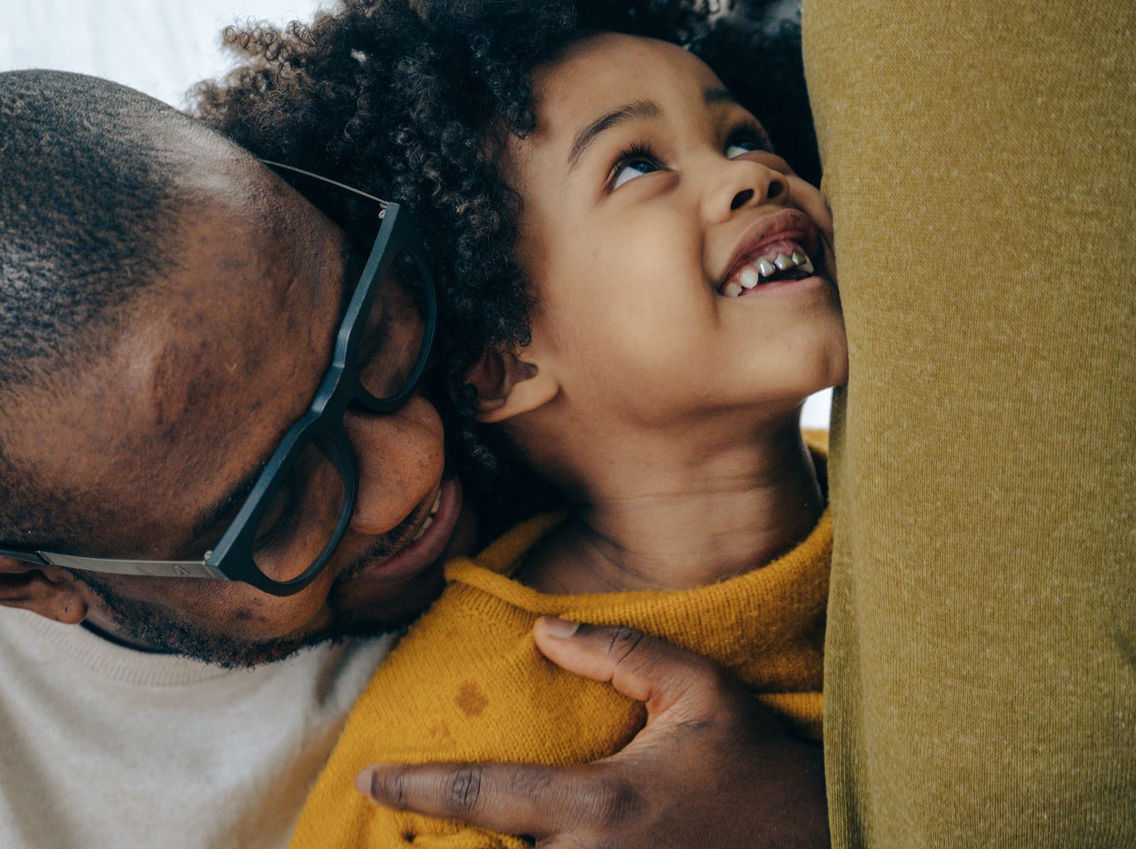 A Black father sharing an everyday moment with his child